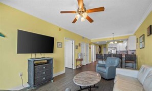 Living room with awesome view, leather queen sleeper sofa with memory foam mattress, 2 leather rocker/swivel recliners, 55" SMART TV & balcony access