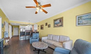 Living room with awesome view, leather queen sleeper sofa with memory foam mattress, 2 leather rocker/swivel recliners, 55" SMART TV & balcony access