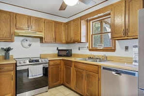 Warm wood cabinets & tons of countertop space in the spacious Kitchen.