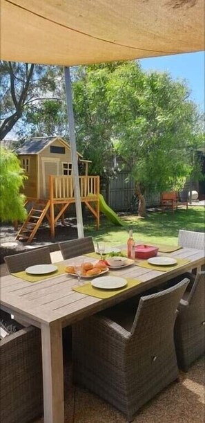 Outdoor dining  and cubby house for children.