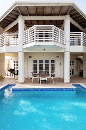 Luxurious poolside deck overlooking the ocean.