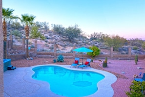 Enjoy the beauty of natural desert behind our home.