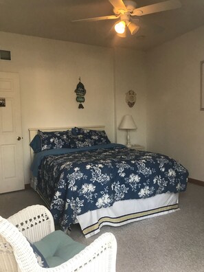 Bedroom on main floor w patio door to deck and queen bed