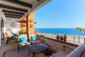 Spacious oceanfront balcony with decorative ceiling beams and gorgeous views