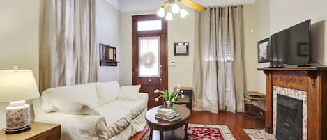 Living room with queen sofa sleeper and large flat screen TV.