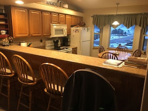 Beautiful kitchen and bar area with everything you need to prepare meals.