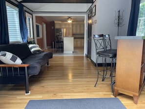 Sunroom has a futon that opens to a full-size bed and bar.