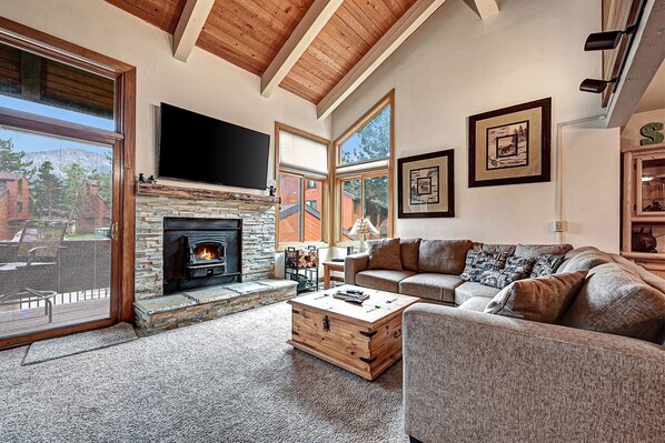 Living Room with a wood burning stove, access to the deck