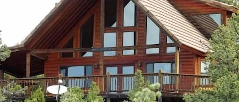 Back deck with  views of mountains and beautiful large ponderosa pine trees.