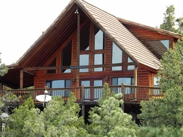 Back deck with  views of mountains and beautiful large ponderosa pine trees.