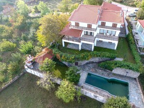 The house, its outdoors and our estate with organic trees.