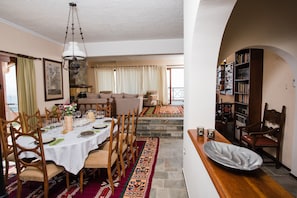 View of the dining room with a background of the living room and the fireplace