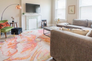 Living room features a Smart TV and L-Shaped Sofa, and a Vintage-Style Reading Chair.