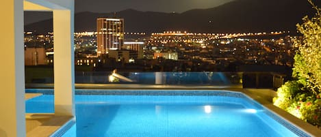 Private swimming pool at roof garden with panoramic city view