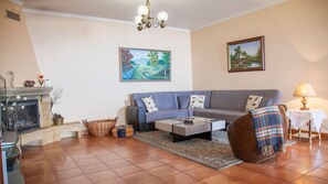 A cozy living room, adorned with warm tones and comfortable furnishings, invites relaxation and tranquility for moments of comfort and joy. #cozy #fireplace