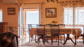 Expansive dining area with ample room for gatherings, featuring tasteful decor and a welcoming atmosphere for enjoyable and memorable dining experiences. #diningroom #oceanview