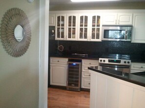 Beautifully updated kitchen - granite countertops, stainless appliances, breakfast bar and a wine frig!