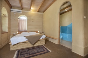 Master bedroom 1 with adjacent restroom and bathtub