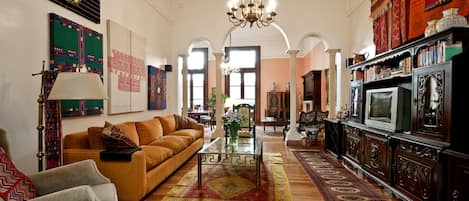 View of family room separated by arches from the formal living area.  Balconies.