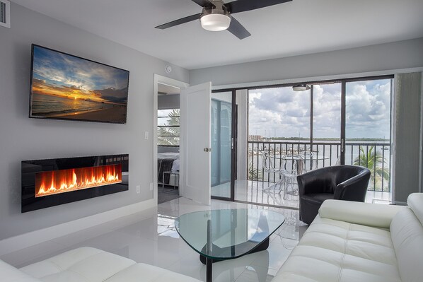 Relax with the stunning water view, cozy  fireplace and a 55inch smart Tv
