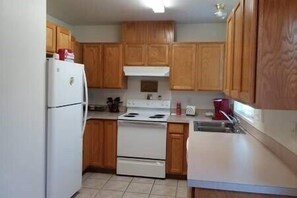 Kitchen fully stocked with dinnerware, cookware, spices just grab some groceries