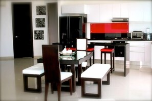 Fully-equipped, modern kitchen, bar area, and dining for six