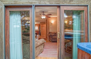 The door leading to the hot tub is in the living room.