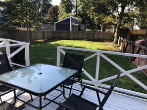 Large furnished patio with BBQ and nice green space in backyard!