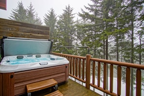 The hot tub is located on the main level balcony.