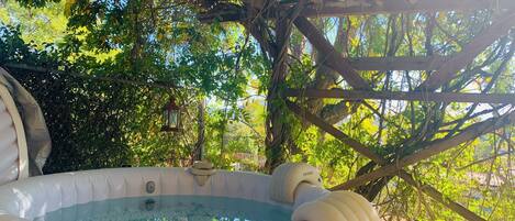 Hot-tube under a wonderful pergola, in a garden full of flowers & birds.