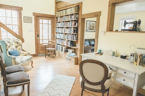 Library with large desk & built-in bookcase is the central feature of the house