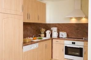Prepare meals in the full kitchenette and enjoy them at the dining table.
