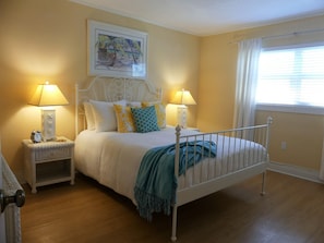 Bright and sunny master bedroom with queen bed.