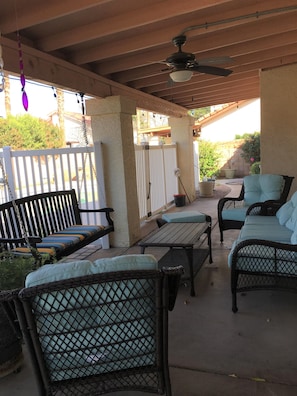 cozy backyard seating with swing and BBQ