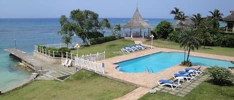 View from the apartment balcony
 of the Caribbean Sea, pool, gazebo and grounds.