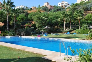 Relax by the pool set in a tropical garden