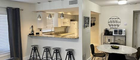 Open living area with kitchen table and counter seating