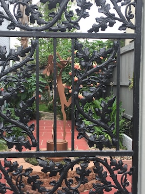 Traditional wrought iron enclosure welcomes you  to our beautiful
 courtyard