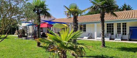 La terrasse sud avec ses parasols multicolores et ses 3 voiles d'ombrage