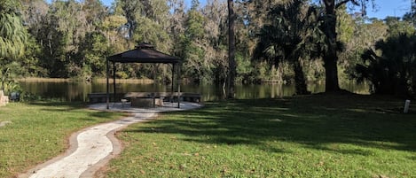 Large fire pit w/ chairs, bench, and gazebo right at the river's edge. 