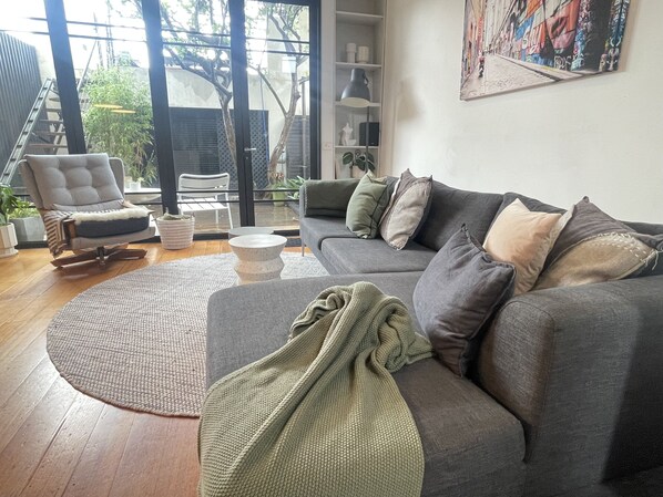 Lounge room looking to back deck and upper terrace with city views
