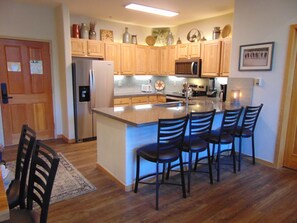 Newly remodeled kitchen with seating for four at the peninsula.