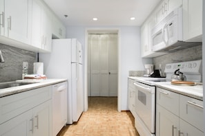 Newly remodeled, full service kitchen with range, dishwasher and refrigerator.