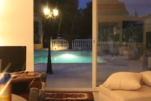 The view from Vichelda Cottage, the large swimming pool at  night