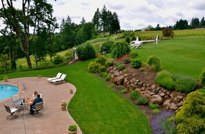 View from the bedroom deck. Guests lunching  by the pool with their helicopter