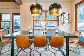 Comfortable seating for 10 guests at the dining room table. You'll find 8 leather slope chairs with 2 padded folding chairs in the pantry.