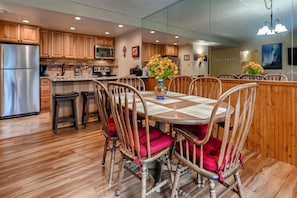 Dining table seats 6 and 4 barstools at the breakfast bar