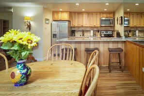 Dining table seats 6 and 4 barstools at the breakfast bar