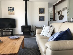 Upstairs living area adjacent to kitchen with slow combustion fireplace 