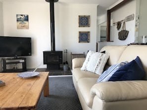 Upstairs living area adjacent to kitchen with slow combustion fireplace 